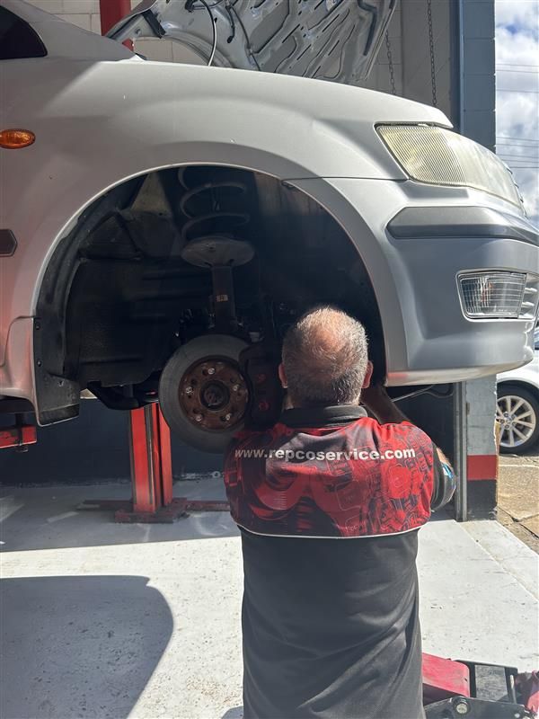 A Person is Fixing a Brake Pad on a Car — Pelican Motors Service Centre In Caloundra West, QLD 