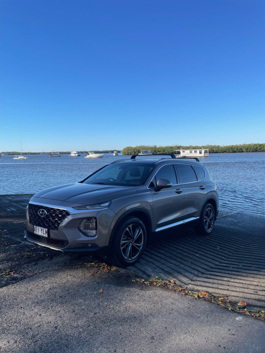 A Hyundai Santa Fe is Parked Next to a Body of Water — Pelican Motors Service Centre In Caloundra West, QLD