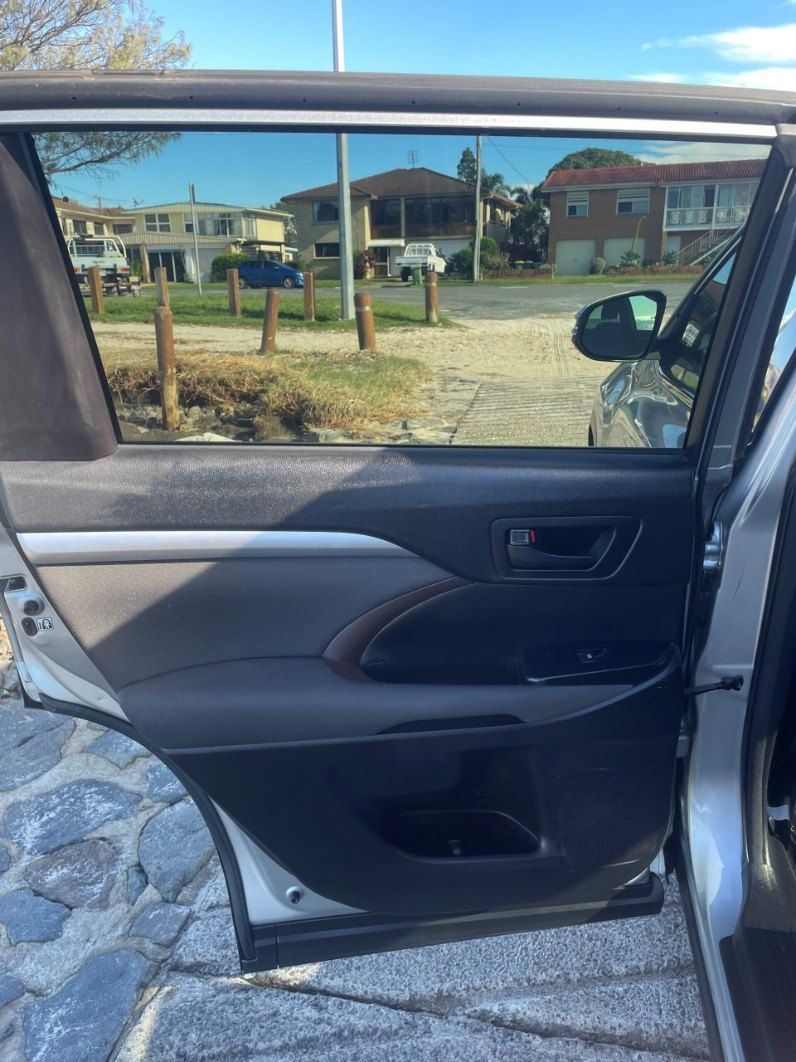 The Back Door of a Silver Car is Open and Looking Out the Window โ Pelican Motors Service Centre In Caloundra West, QLD