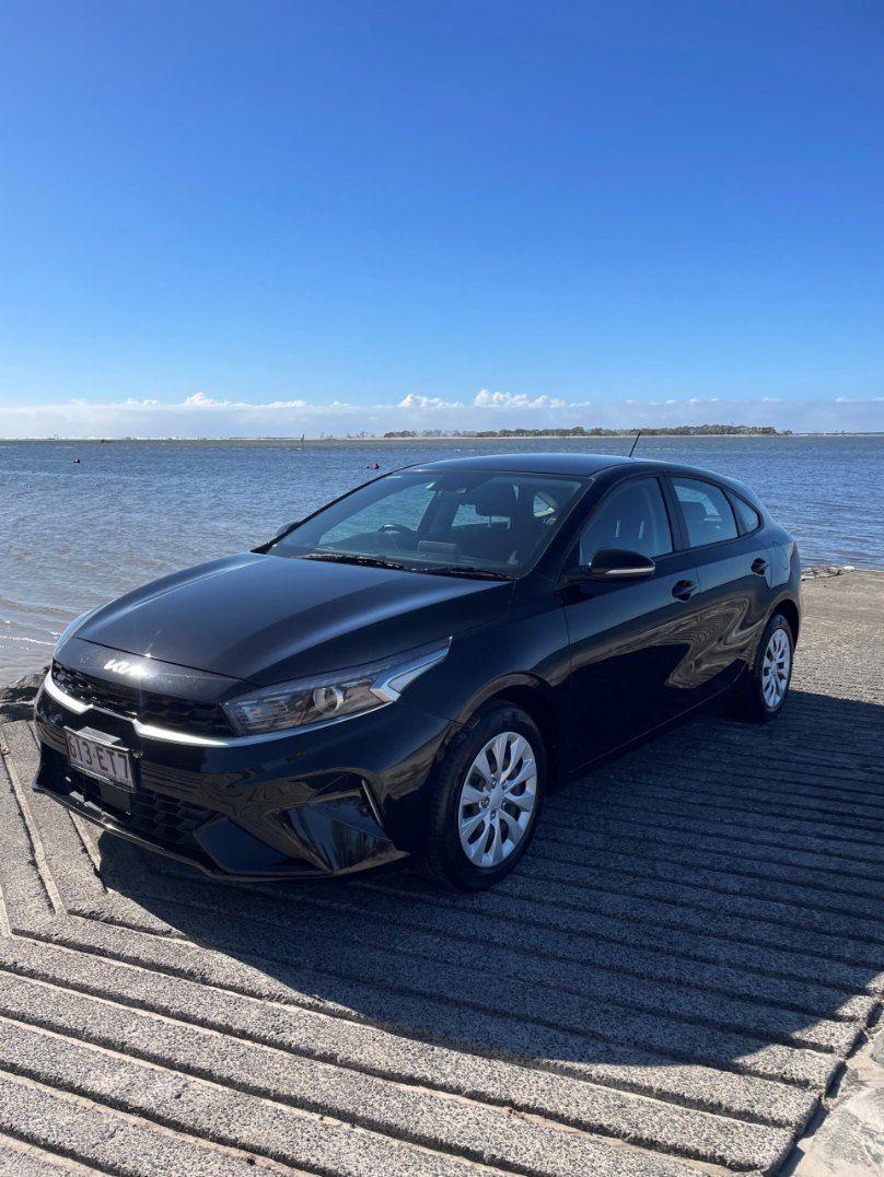A Black Car is Parked on a Dock Next to a Body of Water — Pelican Motors Service Centre In Caloundra West, QLD 