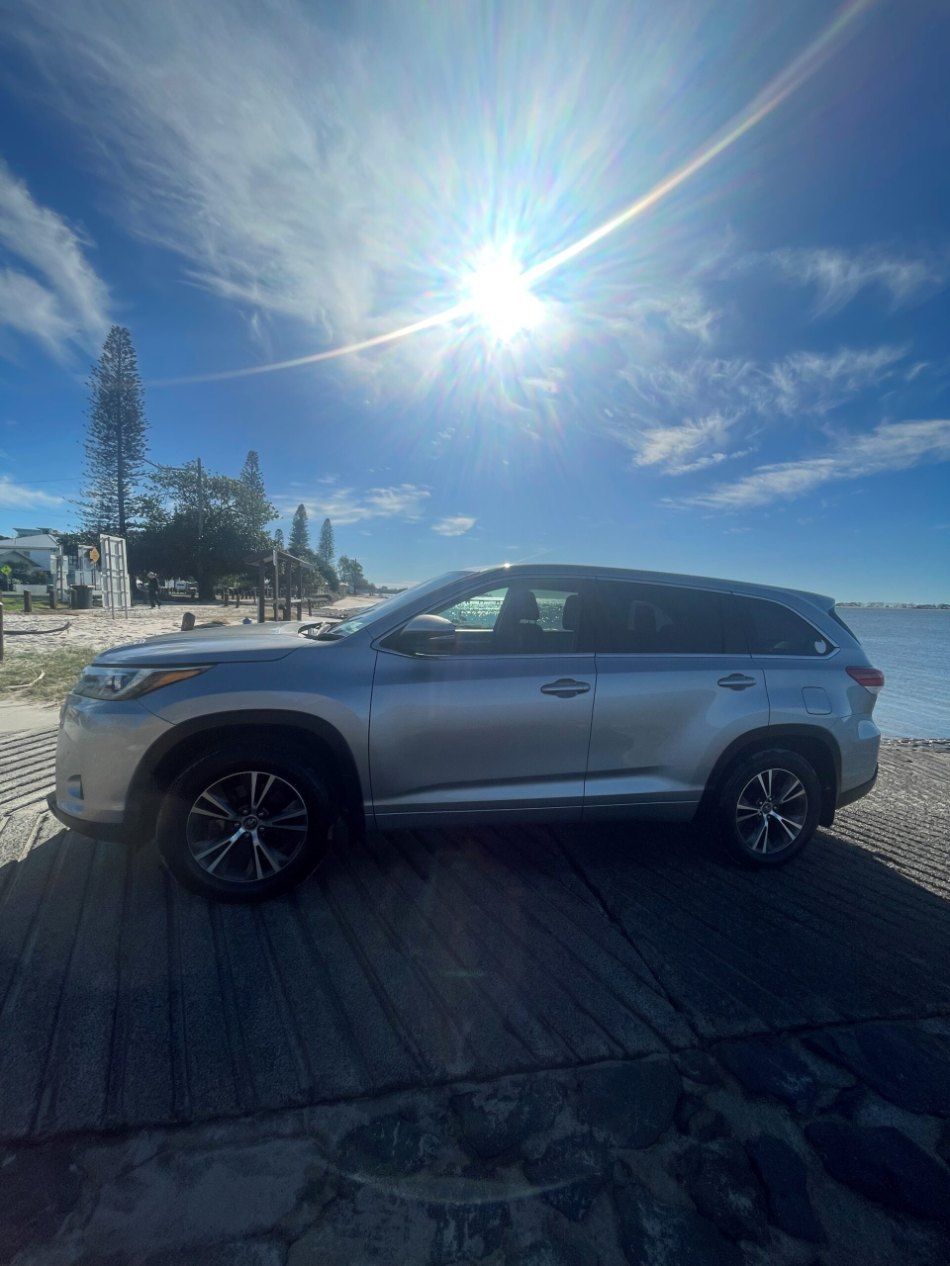 A Silver Car is Parked on the Side of the Road Next to a Body of Water โ Pelican Motors Service Centre In Caloundra West, QLD