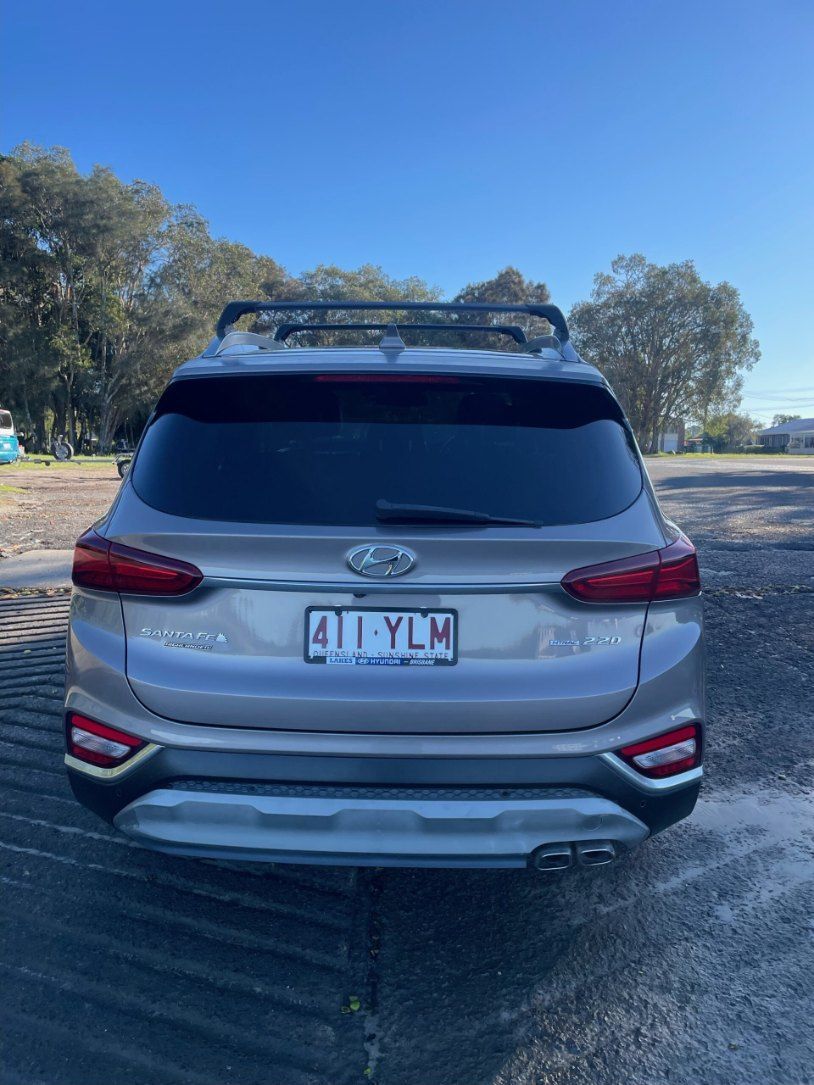 A Silver Car With a License Plate That Says 411ylm is Parked in a Parking Lot — Pelican Motors Service Centre In Caloundra West, QLD
