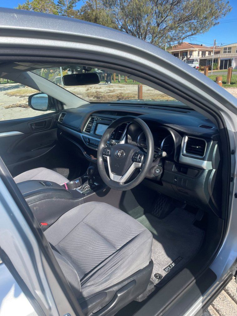 The Interior of a Silver Car With the Door Open and the Steering Wheel Visible โ Pelican Motors Service Centre In Caloundra West, QLD