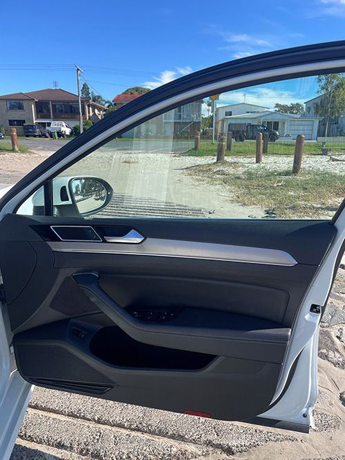 A White Car is Parked on the Beach With the Door Open โ Pelican Motors Service Centre In Caloundra West, QLD