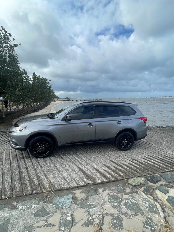 A Silver Suv is Parked on a Beach Next to the Ocean — Pelican Motors Service Centre In Caloundra West, QLD