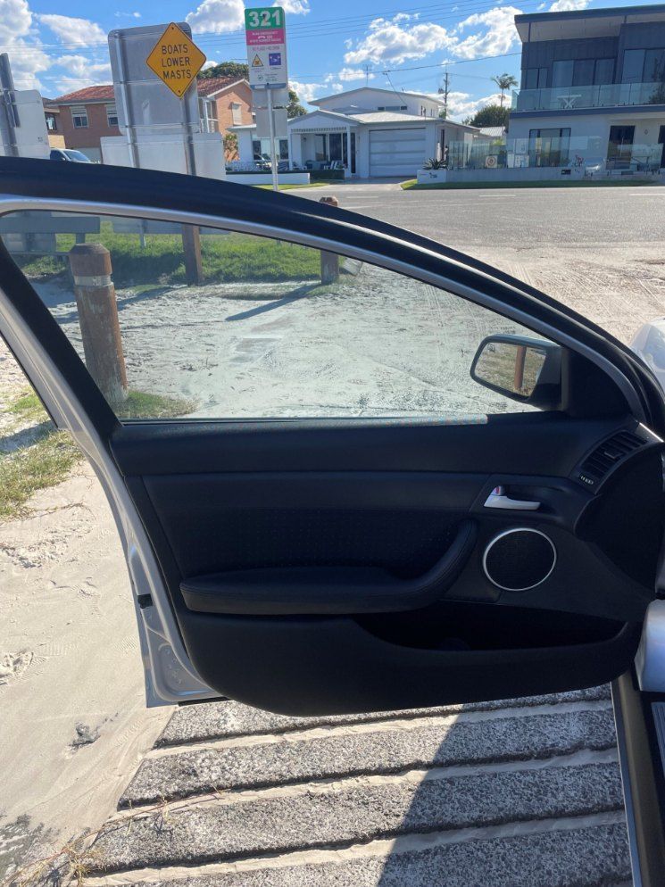 A Car is Parked on the Side of the Road With the Door Open β Pelican Motors Service Centre In Caloundra West, QLD