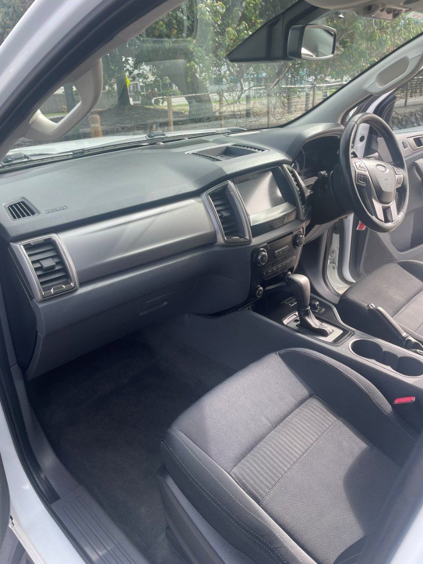 The Interior of a White Car With Black Seats and a Steering Wheel β Pelican Motors Service Centre In Caloundra West, QLD