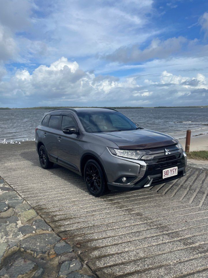 A Mitsubishi Outlander is Parked on a Concrete Ramp Next to the Ocean — Pelican Motors Service Centre In Caloundra West, QLD