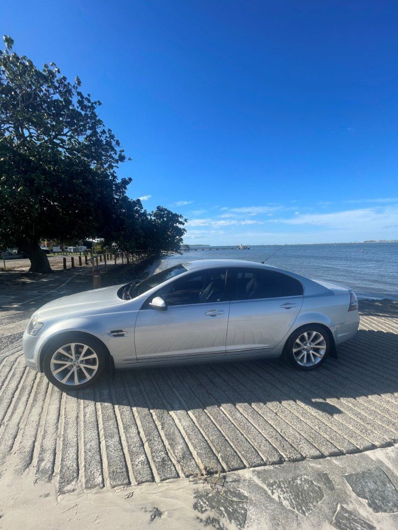 A Silver Car is Parked on a Beach Next to the Ocean β Pelican Motors Service Centre In Caloundra West, QLD
