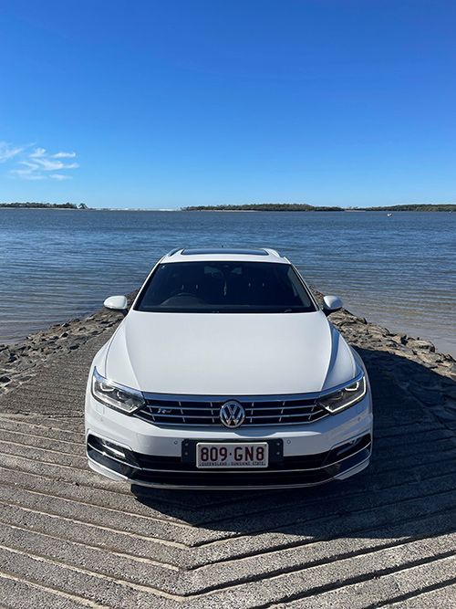 A White Car is Parked on a Dock Next to a Body of Water โ Pelican Motors Service Centre In Caloundra West, QLD