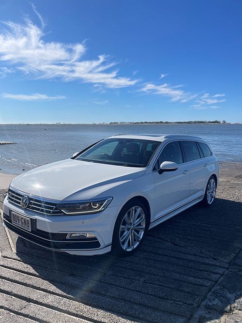 A White Car is Parked on the Beach Next to the Water โ Pelican Motors Service Centre In Caloundra West, QLD