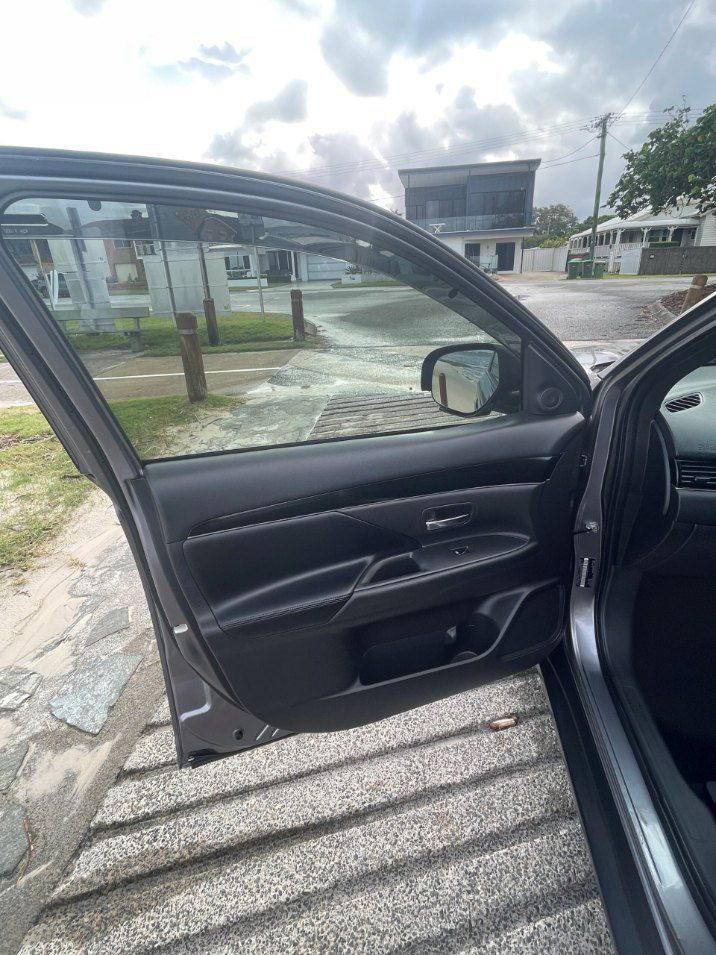 A Car is Parked on the Side of the Road With the Door Open — Pelican Motors Service Centre In Caloundra West, QLD
