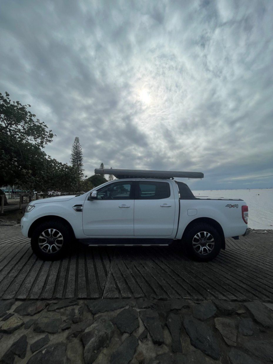 A White Truck With an Awning on Top of It is Parked on a Beach β Pelican Motors Service Centre In Caloundra West, QLD