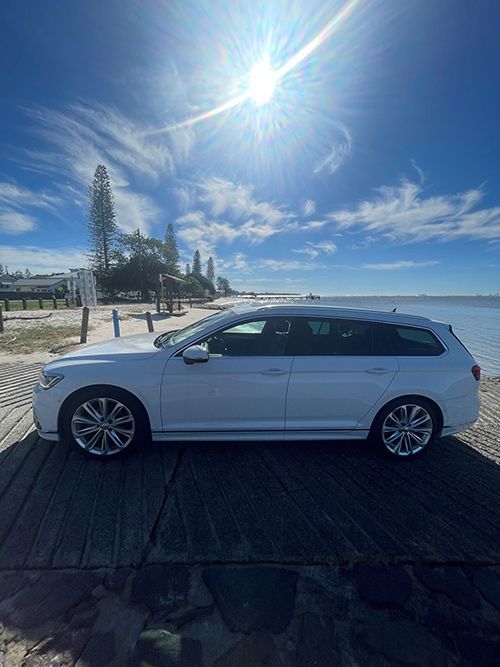 A White Car is Parked on a Wooden Dock Next to the Ocean โ Pelican Motors Service Centre In Caloundra West, QLD