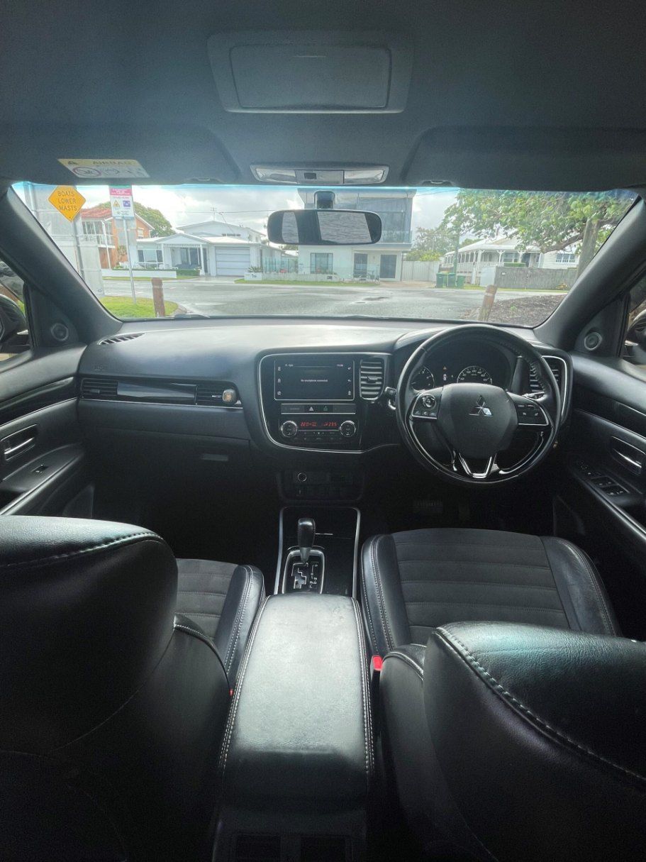 The Interior of a Black Car With a Steering Wheel and Dashboard — Pelican Motors Service Centre In Caloundra West, QLD