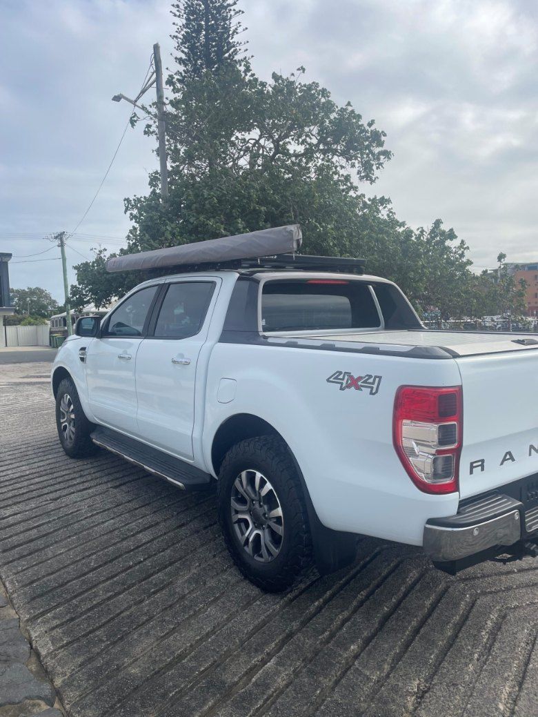 A White Truck With a Canopy on Top of It is Parked in a Parking Lot β Pelican Motors Service Centre In Caloundra West, QLD