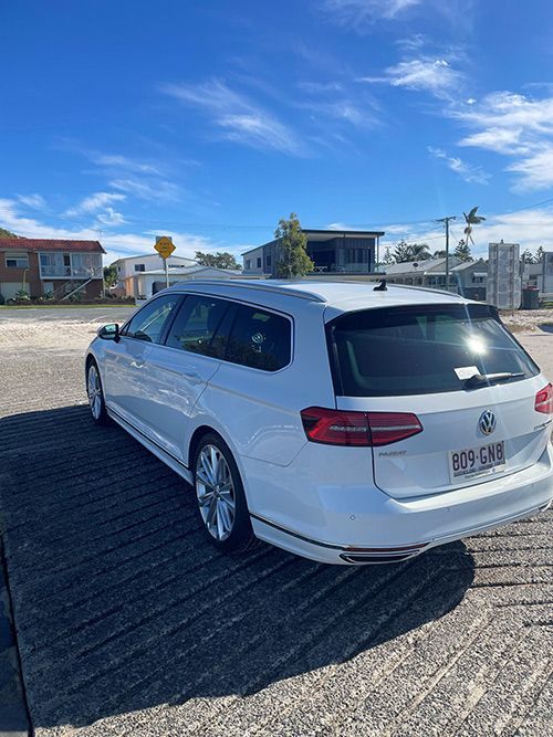 A White Volkswagen Passat Station Wagon is Parked in a Parking Lot โ Pelican Motors Service Centre In Caloundra West, QLD