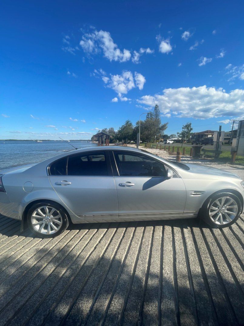 A Silver Car is Parked on a Wooden Dock Next to a Body of Water β Pelican Motors Service Centre In Caloundra West, QLD