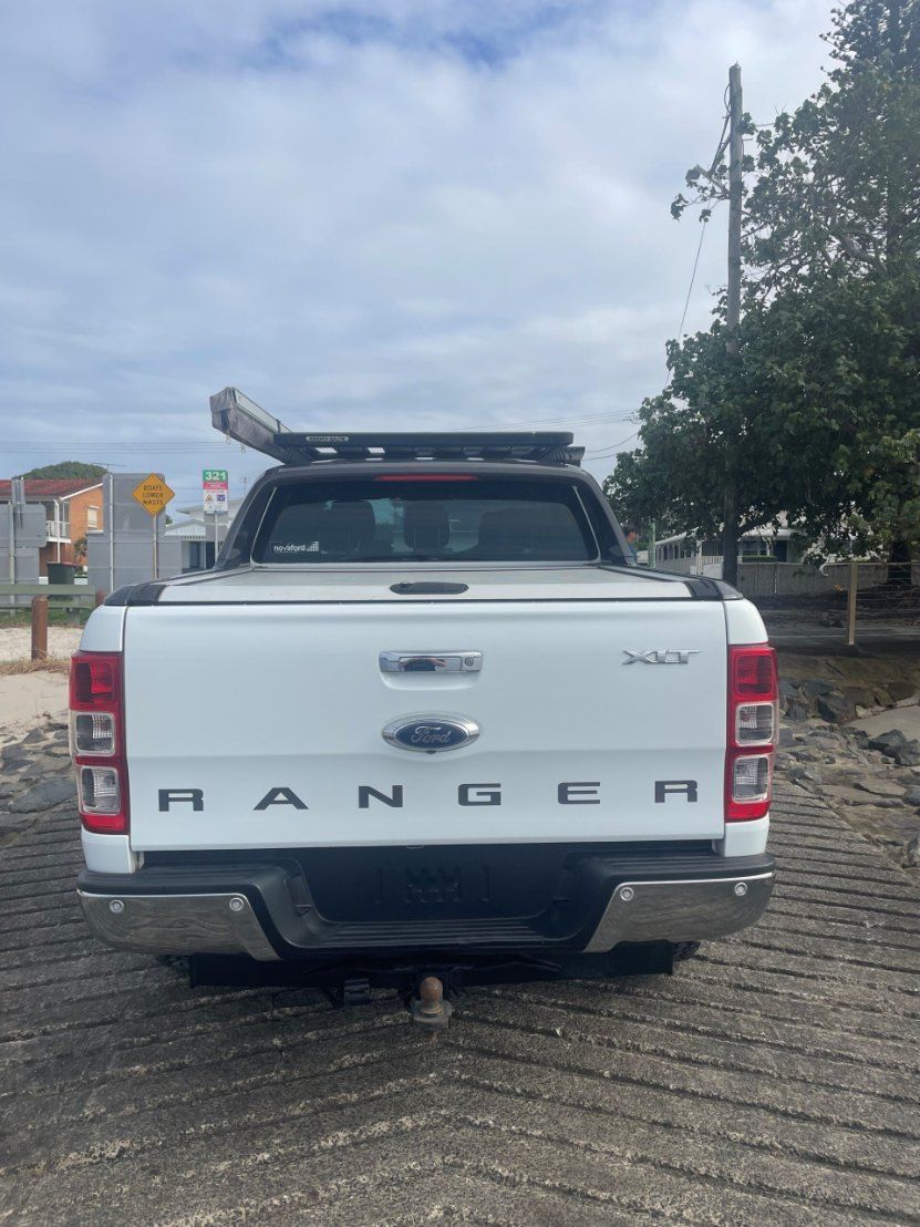 The Back of a White Ford Ranger Truck is Parked on a Brick Road β Pelican Motors Service Centre In Caloundra West, QLD