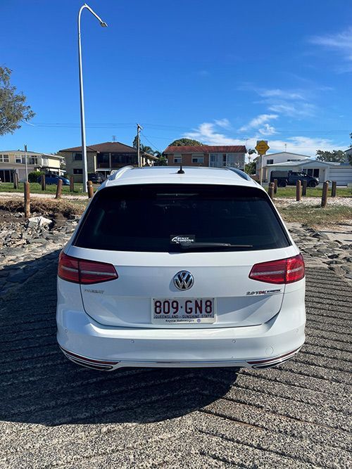 A White Volkswagen Station Wagon is Parked on the Side of the Road โ Pelican Motors Service Centre In Caloundra West, QLD