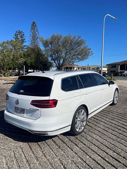 A White Volkswagen Passat Station Wagon is Parked in a Parking Lot โ Pelican Motors Service Centre In Caloundra West, QLD