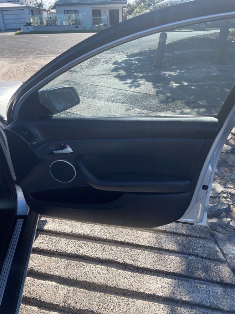 A Car With the Door Open is Parked on the Side of the Road β Pelican Motors Service Centre In Caloundra West, QLD