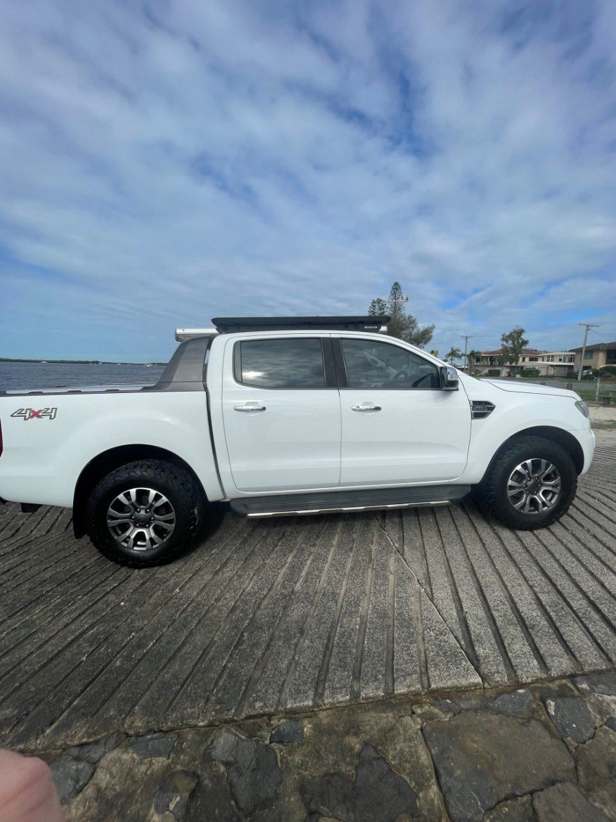 A White Ford Ranger Pickup Truck is Parked on the Side of the Road β Pelican Motors Service Centre In Caloundra West, QLD