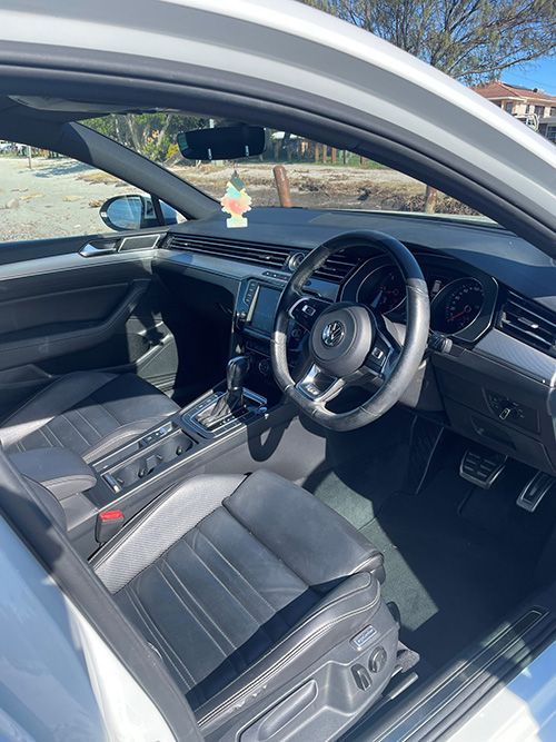 The Interior of a White Car With the Door Open and the Steering Wheel Visible โ Pelican Motors Service Centre In Caloundra West, QLD
