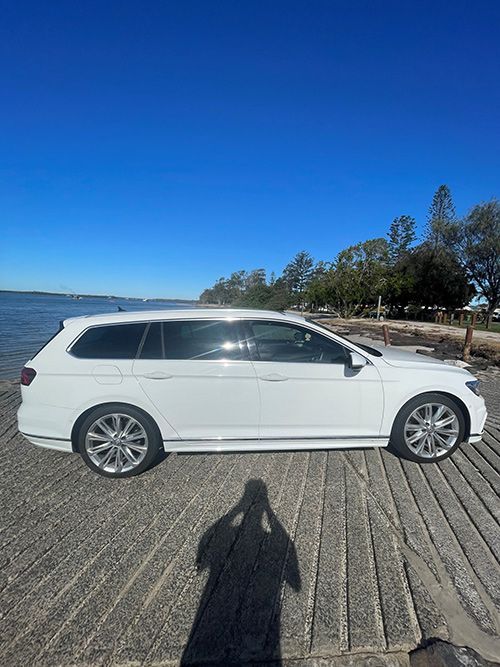 A White Car is Parked on a Dock Next to a Body of Water โ Pelican Motors Service Centre In Caloundra West, QLD
