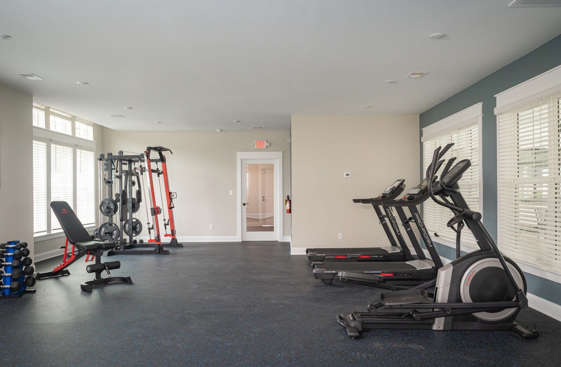 A large gym with a lot of equipment and a lot of windows.