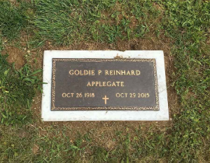 Gravestone plaque on grass with gold lettering for Goldie P. Reinhard Applegate, 1918–2019