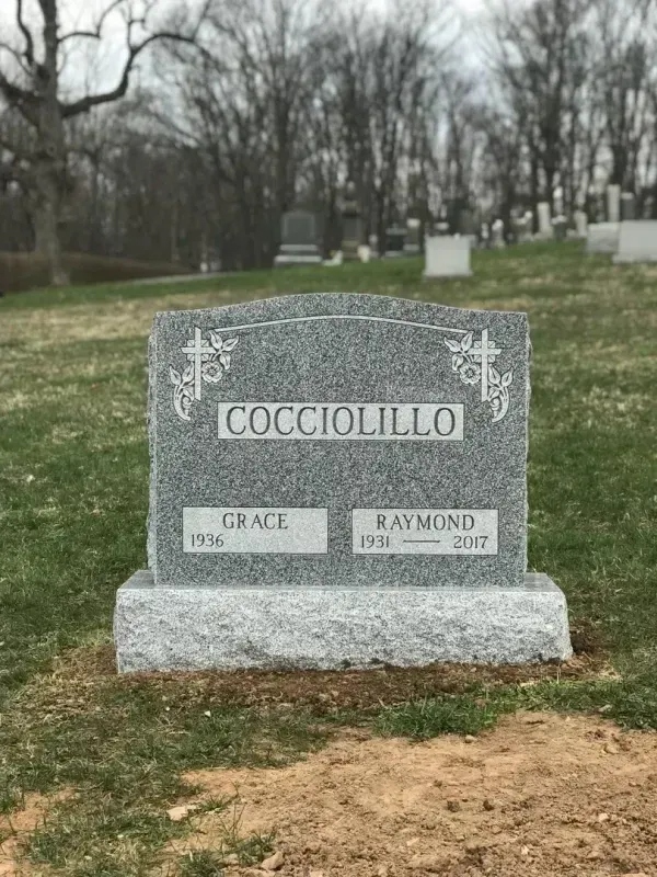 Gray granite gravestone in a cemetery, engraved