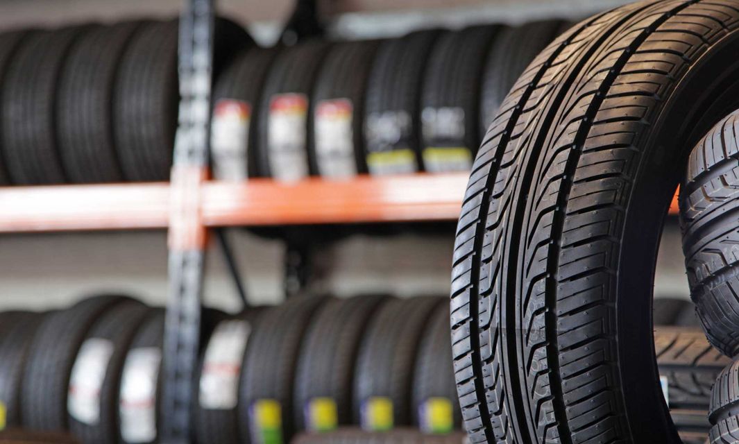 A tire is sitting on top of a stack of tires.