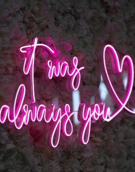 A neon sign that says `` it was always you '' with a heart.