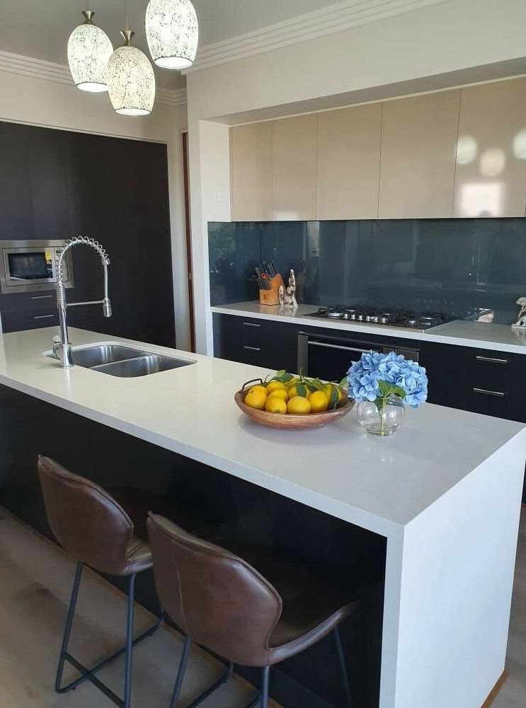 A Kitchen With a Large Island and a Bowl of Fruit on It — A Place 2 Shine In Chisholm, NSW