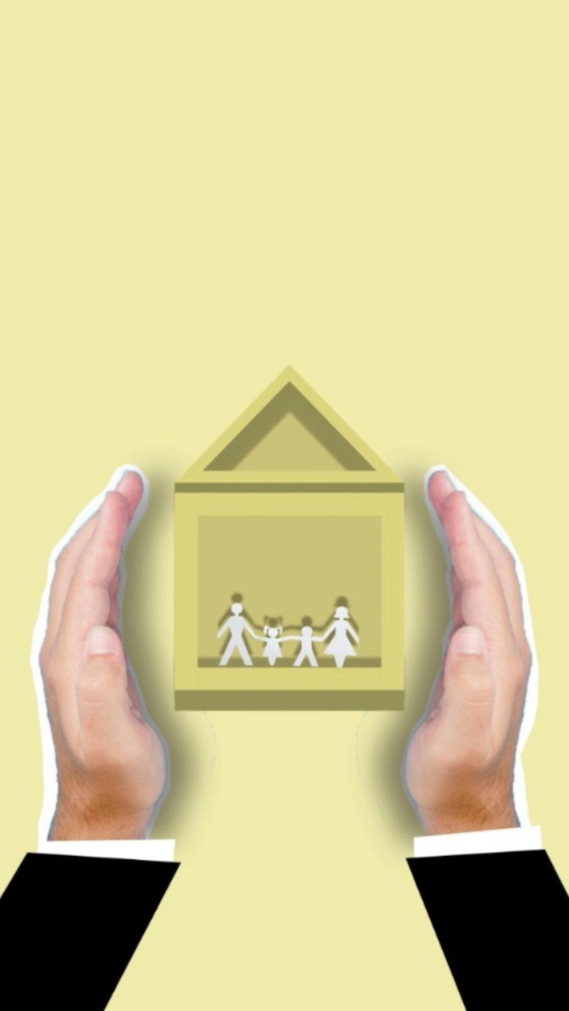 Hands holding a small house icon with a family silhouette inside on a pale yellow background