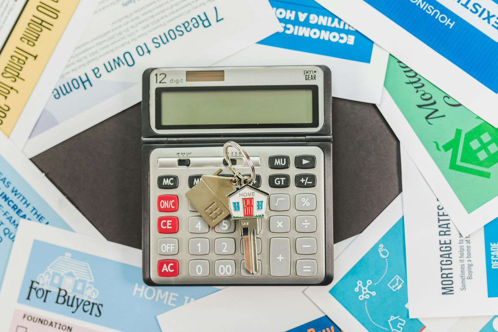 Calculator with keys on a collage of banknotes and financial papers, suggesting budgeting or accounting