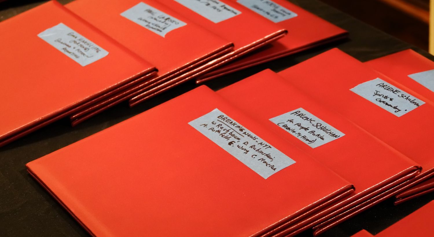 Red folders with white labels, possibly containing documents.