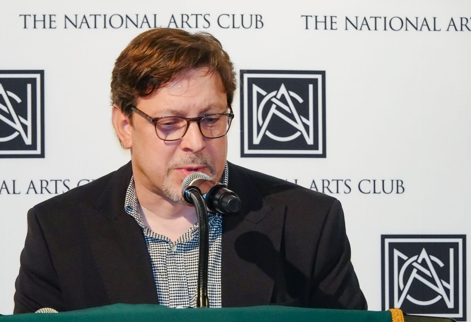 Man speaking at a podium with 
