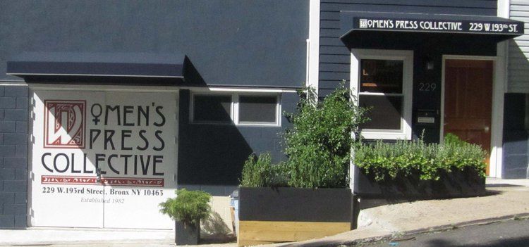Exterior of Women's Press Collective building with signage, awnings, and plants in planters.