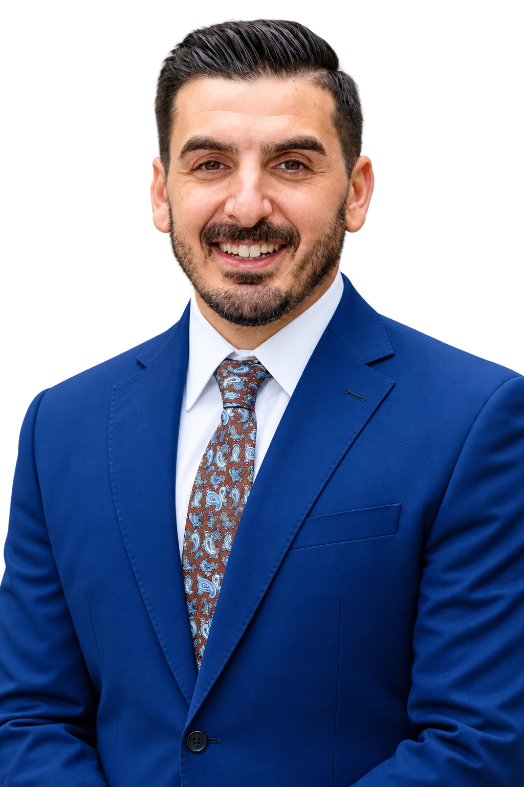 Man in a blue suit and patterned tie, smiling against a white background.
