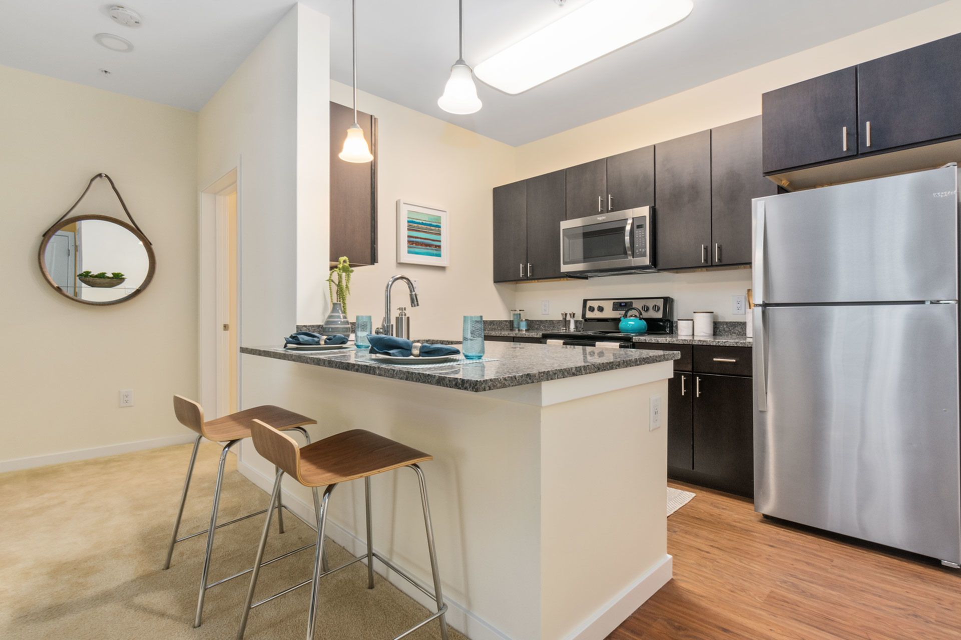 Gradient apartment kitchen with breakfast island.