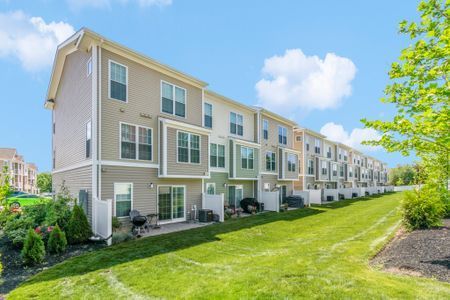 Gradient apartment building daytime exterior view with the townhome backyard. 