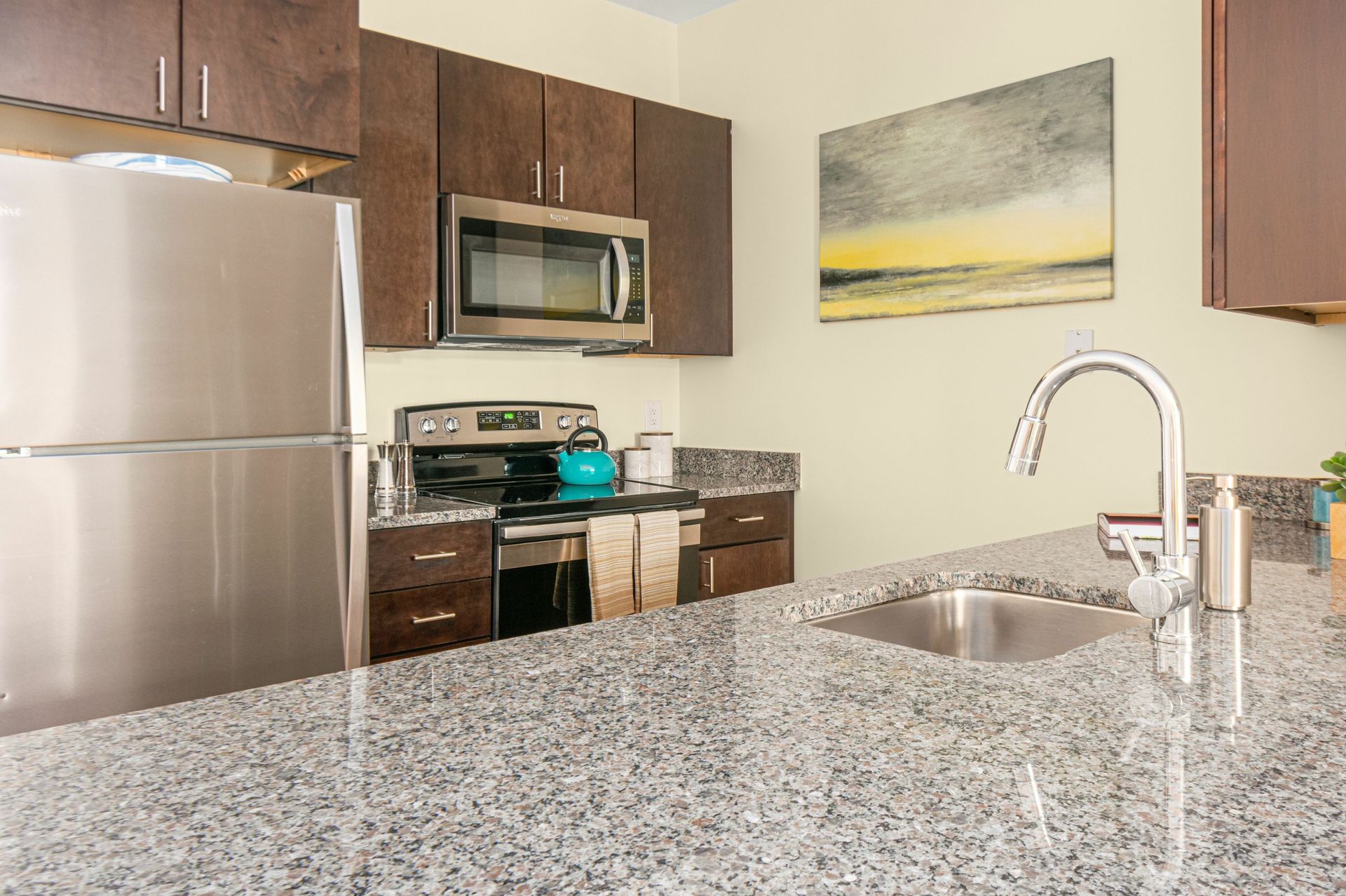 Gradient apartment kitchen with oversized island.