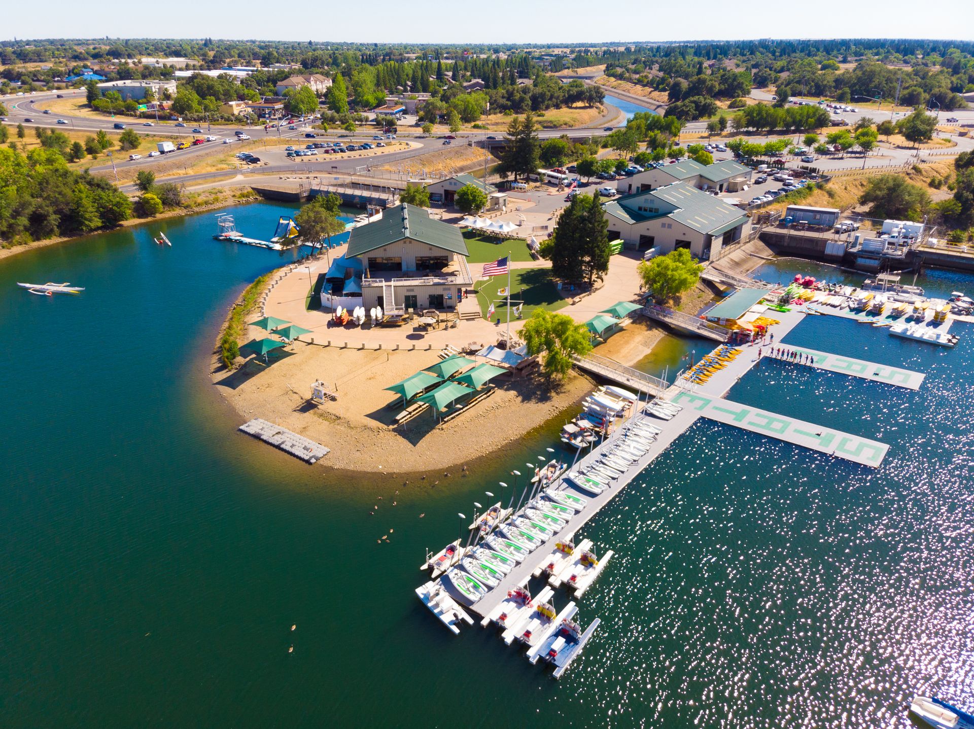 An aerial view of a lake with boats docked at a marina.