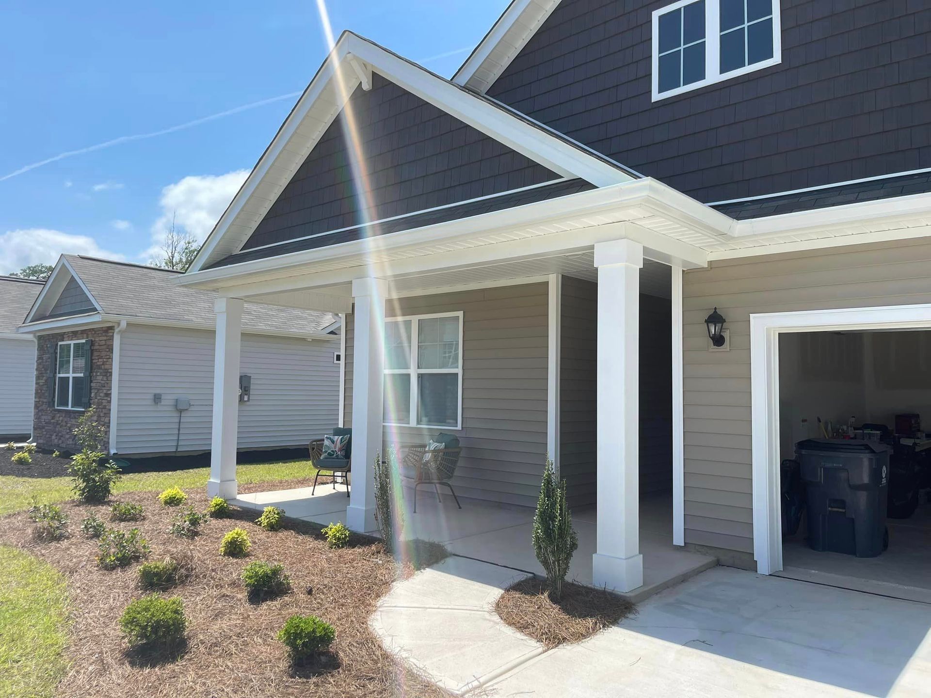 a house with a small front porch and new seamless gutters in conway sc by SNL Seamless Gutters