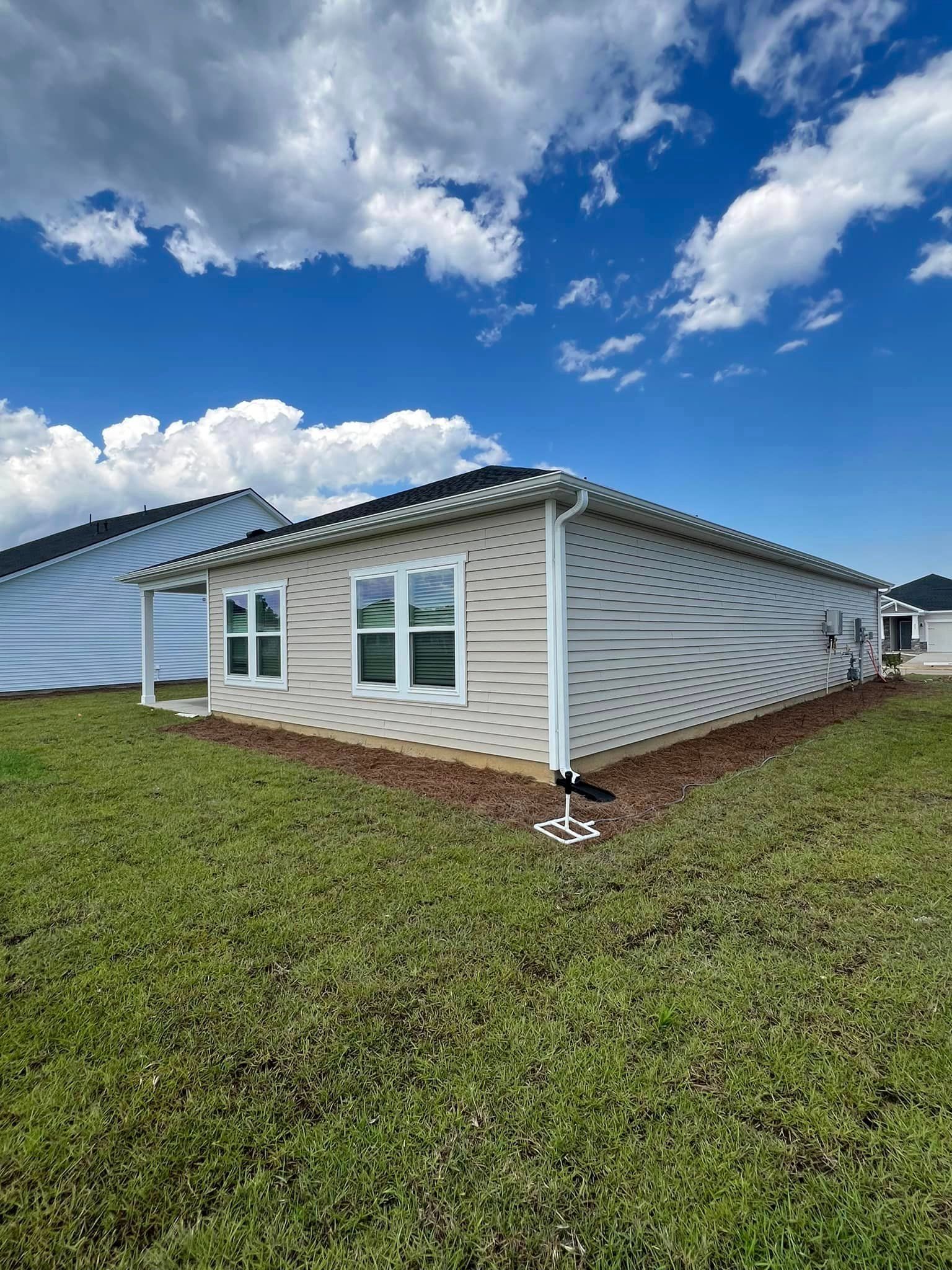 A small house with a porch and newly repaired gutter in Mullins.