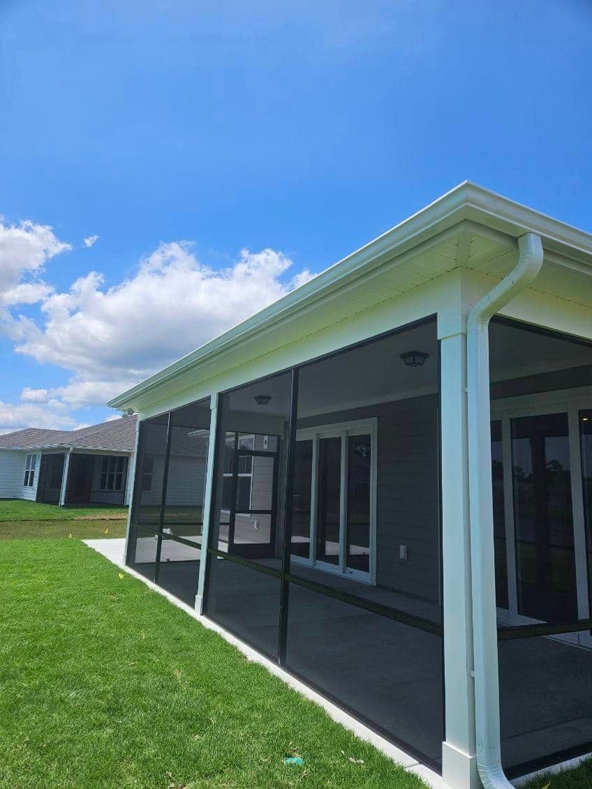A screened in porch with a gutter in Johnsonville