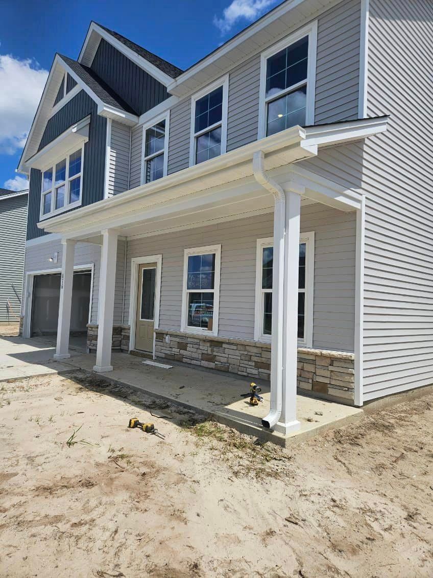 A large house with a porch, a lot of windows and new gutter in Galivants Ferry