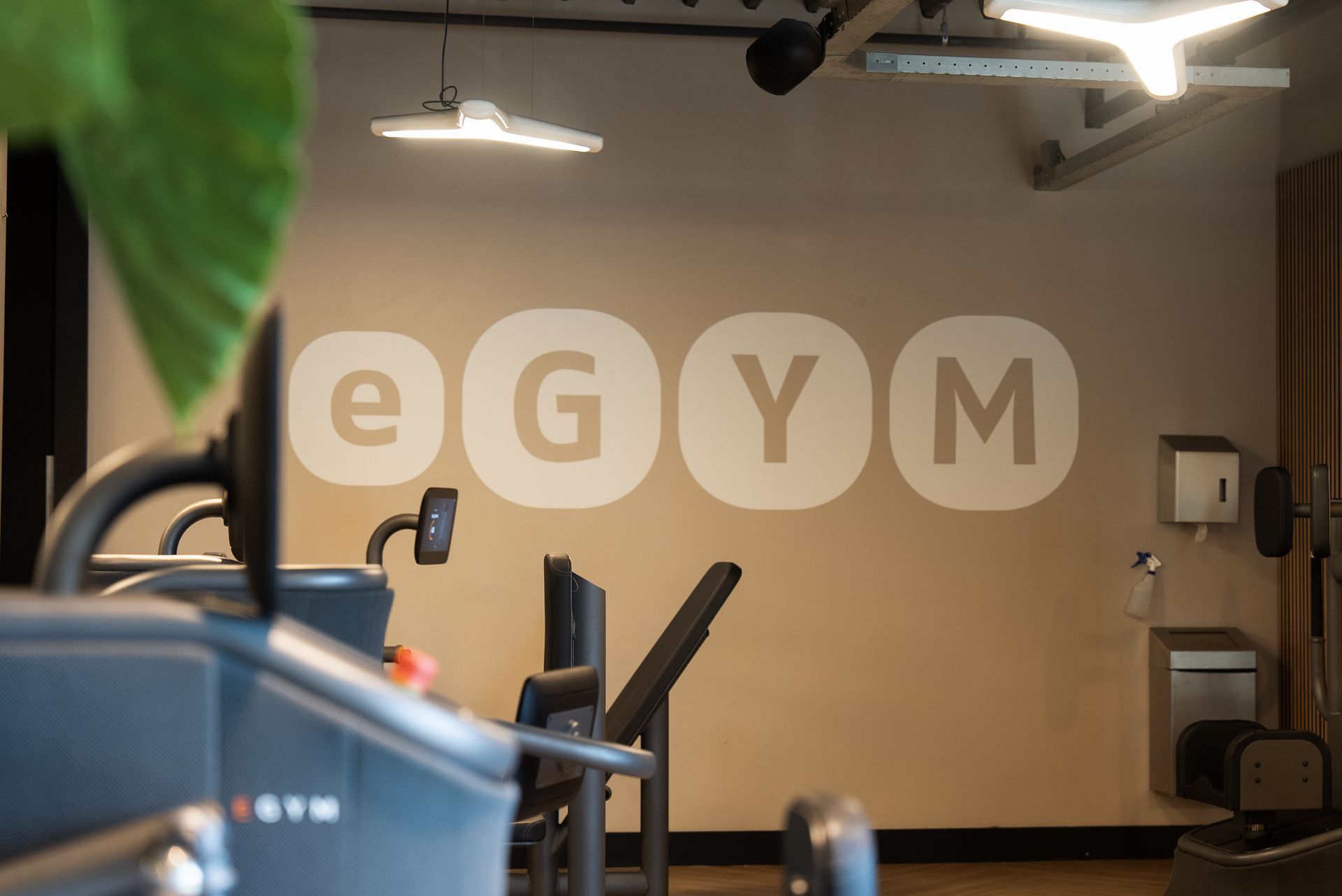 Een sportschool met een bord aan de muur waarop staat 'e gym'